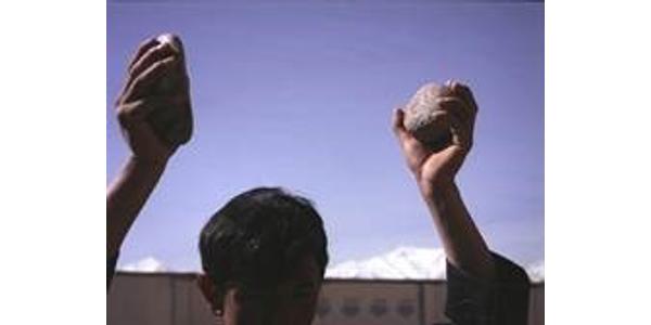 Lida Abdul (b.  1973, Kabul, Afghanistan; lives and works in Kabul and Los Angeles); still of Clapping With Stones; 2005; 16 mm film transferred to DVD; 5 min.; image courtesy of the artist and Giorgio Persano Gallery 