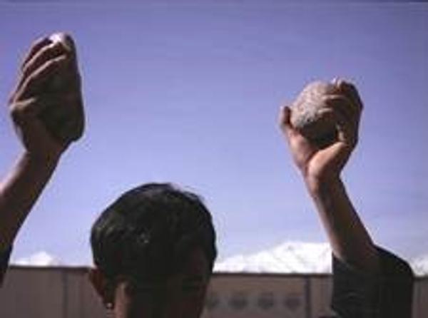 Lida Abdul (b.  1973, Kabul, Afghanistan; lives and works in Kabul and Los Angeles); still of Clapping With Stones; 2005; 16 mm film transferred to DVD; 5 min.; image courtesy of the artist and Giorgio Persano Gallery 