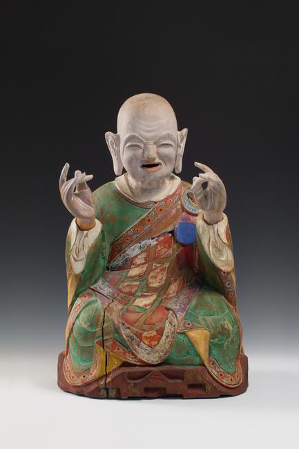 From Koo New York.  KOREAN: Rare Buddhist Polychrome Wood Figure of a Seated Nahan, Joseon Dynasty, 18th/19th century, original consecrated sutra pages remaining inside head cavity, the front carved with the identifier number "two" corresponding to Kanakavatsa (second disciple of historical Sakyamuni Buddha) Height 20 1/2 in.  (52 cm)