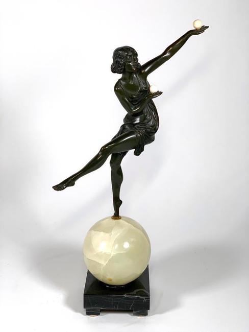 Art Deco bronze sculpture by Marcel Andre Bouraine (French, 1886-1948), titled The Juggler (1925), depicting a woman juggling as she balances on an onyx sphere (est.  $2,000-$4,000).