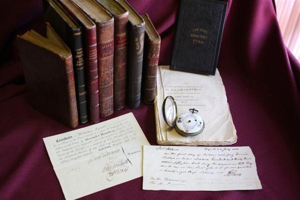 Included in the exhibition are rare books, newspapers, pamphlets, manuscripts, letters, and art relating to Aaron Burr and his contemporaries.  Burr's pocket watch is shown in the foreground with the only known portrait of his first wife and the earliest known portrait of his daughter Theodosia.