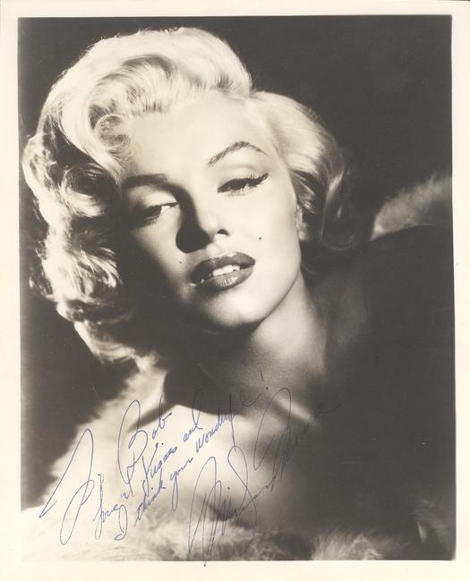 Signed and inscribed portrait photograph of Marilyn Monroe, inscribed to “Bob” (likely Robert Mitchum, Monroe’s co-star in the 1953 film River of No Return) (est.  $12,000-$14,000).