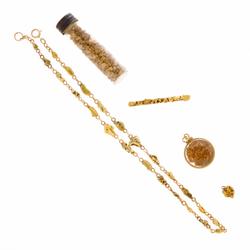 Five-piece group of gold nuggets and nugget jewelry comprising a 16 ½ inch long necklace, pin, two pendants and a jar of loose nuggets, gross weight approx.  65 grams (est.  $1,500-$2,000).