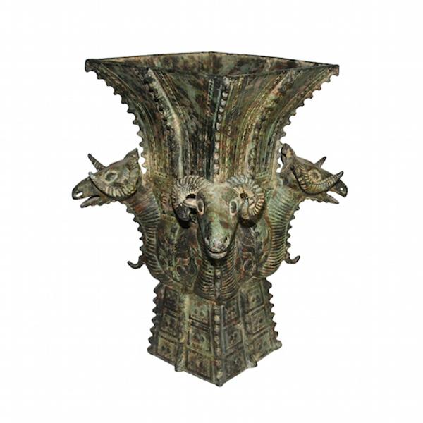 Archaic Chinese ritual bronze wine vessel with four ram heads.  Of the Shang Dynasty.  