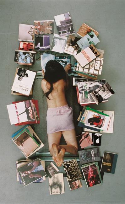 Rosemarie Trockel, Living Means Not Good Enough, 2002.  Chromogenic color print, thirty books, and a magazine, approximately 76 3/4 x 46 2/3 x 7 7/8 inches (195 x 118.5 x 20 cm).  Courtesy the artist and Sprüth Magers, Berlin.  © 2016 Rosemarie Trockel, VG Bild-Kunst, Bonn 2016 resp.  ARS