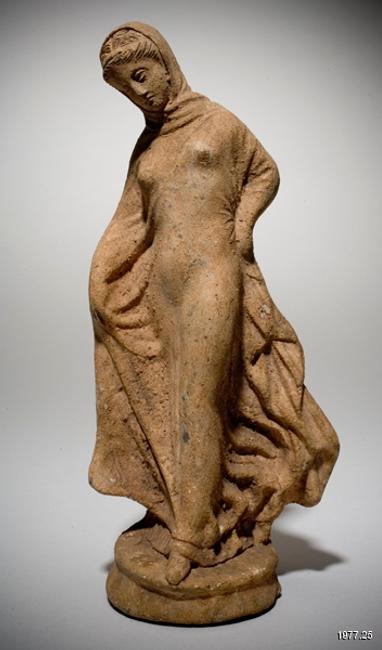 Greek (Hellenistic) Tanagra figurine of a standing draped woman late 3rd century B.C.E.  (probably modern) Terracotta overall: 8 1/4 in.  x 3 3/4 in.  x 3 in.  (21 cm x 9.5 cm x 7.6 cm) Gift of Mrs.  Brooks B.  Thayer (Louise Govett, Class of 1956) 1977.25