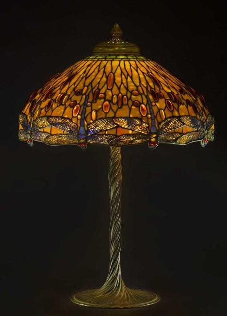 The top lot of the auction was this Tiffany Studios (N.Y.) drop head Dragonfly lamp, circa 1910, having a verdigris patinated leaded glass shade with 'jewel' cabochons ($200,000).  