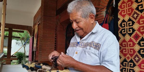 J.  Isaac Vásquez García, master weaver and dyer, is featured in the Craft in America: Borders episode.  Photo by Denise Kang.  