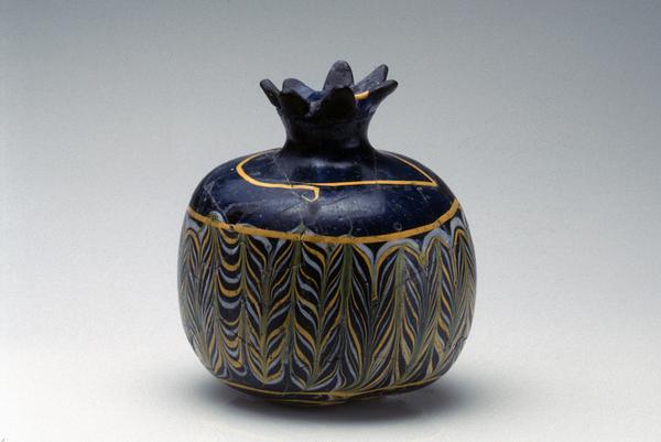 Pomegranate shaped vessel.  Egypt, 12th century BCE.  Core-formed glass.  3 ¾ in.  x 3 ¾ in.  Newark Museum.