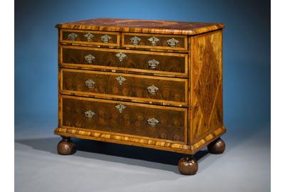 Oysterwood veneers, parquetry and bun feet distinguish this rare and exquisite William and Mary period chest.