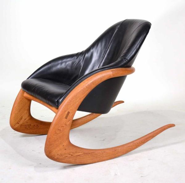 Black leather crescent rocker designed by Wendell Castle (Am., 1932-2018) ($17,500).