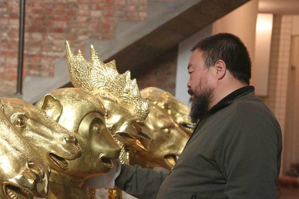 Ai Weiwei in his Beijing studio examining early versions of heads from Circle of Animals/Zodiac Heads: Gold, 2010