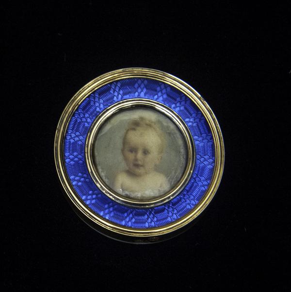 Miniature portrait in a medallion showing the infant Prince Sergei Sergeevich, 1898.  Watercolor on ivory, 14K yellow gold, blue guilloche enamel, ivory back, 1 1/2 x 1/4 inches (framed).  Promised gift of Marina Belosselsky-Belozersky Kasarda