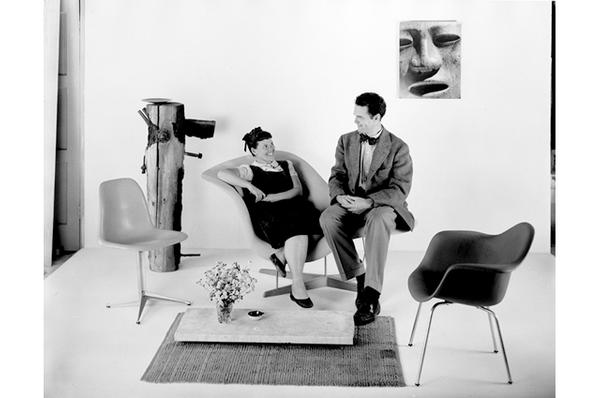 Charles and Ray Eames sitting on the La Chaise prototype, 1948.  © Eames Office LLC