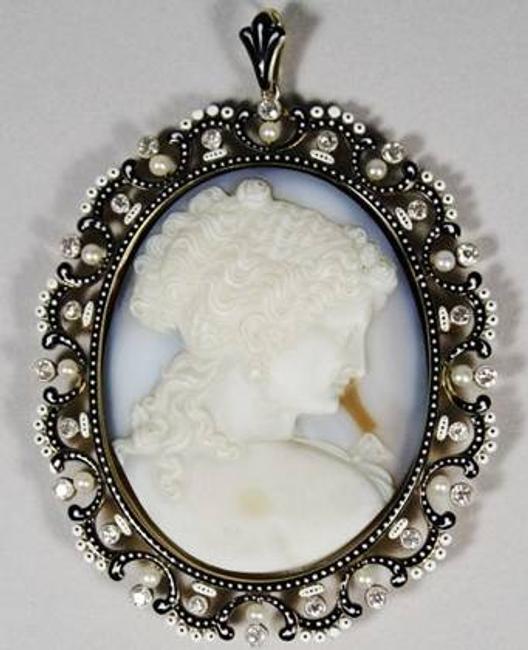 A stunning Russian Agate Cameo with 18kt yellow gold, diamond and pearl frame and dramatic black and white enamel.