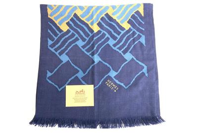 An Hermes Paris cashmere/silk/wool shawl ($200-2,000), rectangular, with a navy blue and a center brick pattern on each side but with different complementary hues, measures 16 ½ by 72 inches.