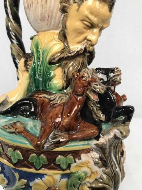 This early and signed ornate horse putti dragon majolica vessel ($400-800) is richly detailed with cupids and putti, horse figurals, swirl and scrolls, 19 inches tall.