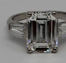 Sparking amid a bevy of fine jewelry pieces is this platinum engagement ring set with a central 5.25-carat emerald-cut diamond flanked by tapered baguettes ($30/50,000).