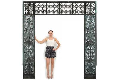 This unique pierced decorated bronze entryway, weighing several hundred pounds ($20/30,000) features a transom with geometric quatrefoil decorated panels and filigree decoration, 125 ½ by 111 1/2 inches.