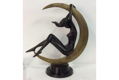 The top lot of the action was a bronze Art Deco statuette of a nude woman reclining inside a crescent moon, 23 by 20 by 9 inches, that went to a phone bidder for $1,905.