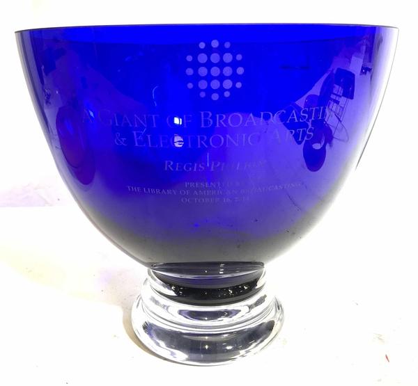 This elegant blue glass award made in Poland ($200-600) is inscribed “A Giant Of Broadcasting & Electronic Arts, Regis Philbin,” presented by the Library of American Broadcasting in 2014.