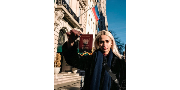 Artist Olive Allen at the Russian Embassy.  Her Burnt Passport NFT will go up on SuperRare on March 4 with proceeds going to humanitarian organizations in Ukraine.  Image courtesy Art in a Time Like This.