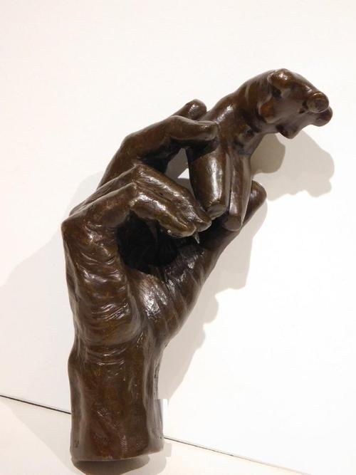 Bronze cast sculpture signed by the renowned French artist Auguste Rodin (1840-1917), depicting a hand holding a female torso, 5.5 inches tall (est.  $80,000-$100,000).