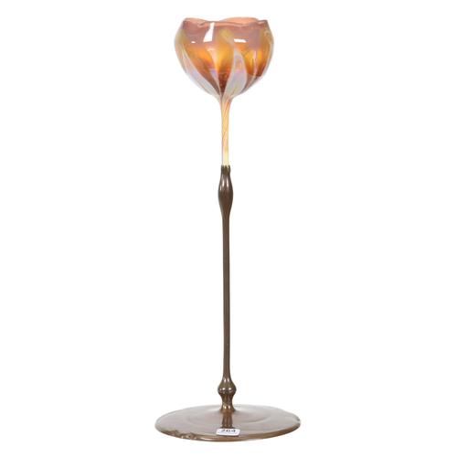 Tiffany Studios #23819 art glass flower form vase, 16 inches tall, having an elegant bronze base and stem holding an art glass “bloom” of lavender and opal pulled feather design.