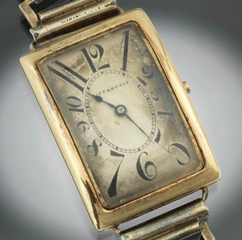 A Gentleman's Patek Philippe 18K Gold Rectangular Curved Wristwatch With "Explosion" Numerals, Very Fine and Rare, Manufactured for Tiffany & Co, ca.  1918