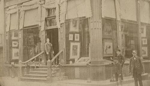 Charles L.  Knoedler (1863–1944), the youngest son of Michael Knoedler, at the gallery's fourth location, a rented brownstone at the intersection of 170 Fifth Avenue and 22nd Street in New York City.  The Getty Research Institute, 2012.M.54