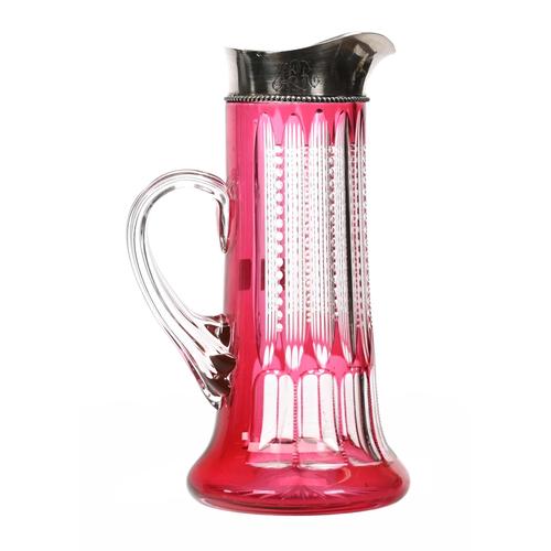 American Brilliant Cut Glass cranberry cut to clear tankard, 10 inches tall, in the Prism and Fluke pattern, with a clear applied ribbed handle, ray cut base and sterling collar marked “J.F.  Fradley”.