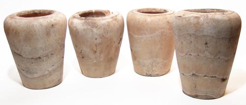 Set of four large Egyptian alabaster canopic jars (Late Period, circa 664-332 BC), each jar carved from a creamy stone with horizontal veins (est.  $9,000-$15,000).