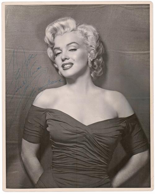 Black and white photograph of Marilyn Monroe signed and inscribed “to Joe” (possibly Joe DiMaggio), unusually large at 11 inches by 14 inches (est.  $20,000-$25,000).