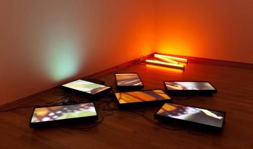 Diana Thater, "Untitled (Butterfly video wall #1)," 1998.  Flat panel monitors, DVD player, synchronizer and orange gels.  SBMA, Museum purchase, the Suzette Morton Davidson Art Acquisition Endowment Fund.  ©Diana Thater 