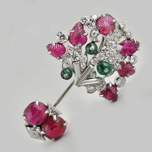 Beautiful jabot pin designed as a stylised foliate motif with carved rubies, diamonds and emerald beads.  Cartier New York c1925 www.hancocks-london.com/