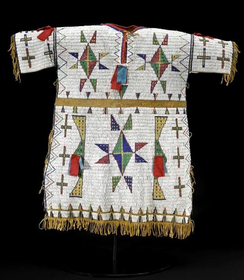 A Sioux fully-beaded buckskin dress (est.  $40/60,000) will be offered by Bonhams & Butterfields in San Francisco on 7 June 2010 during the summer Native American Art auction.  Imaginatively decorated with a profusion of geometric configurations - mostly triangle and diamond forms - the dress is 29-inches in length...  Photo Credit: Courtesy Bonhams & Butterfields 