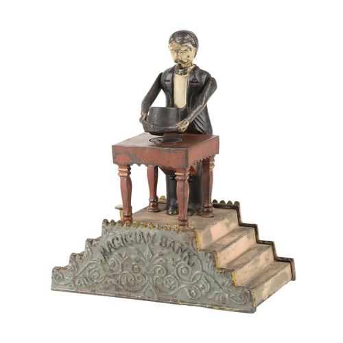 J.  & E.  Stevens painted cast iron magician mechanical bank designed by Charles A.  Bailey, the harder-to-find version with the pink stairs, patented in 1901 (est.  CA$3,000-$3,500).