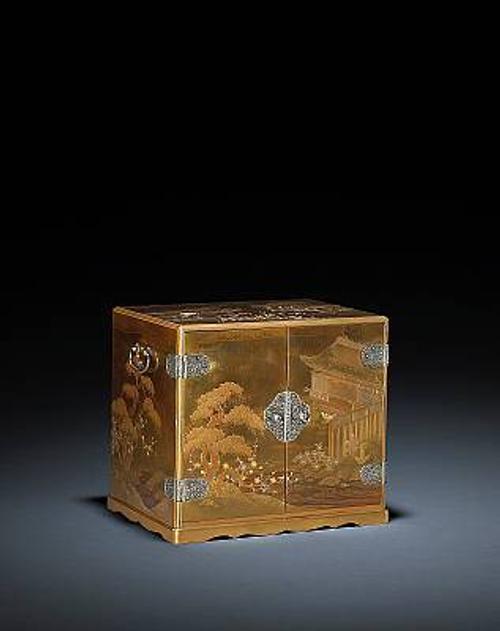 Attributed to Koma Nagafusa the small, rectangular storage box features a continuous design from the "First Warbler" chapter from the Tale of Genji.  Decorated with inlaid plum blossoms and a stream rendered in silver and gold, the doors open to reveal drawers decorated with lozenge designs and silver hardware carved with scrolling vines.  Estimated at $15,000-25,000 the exquisitely detailed piece represents an excellent collecting opportunity.