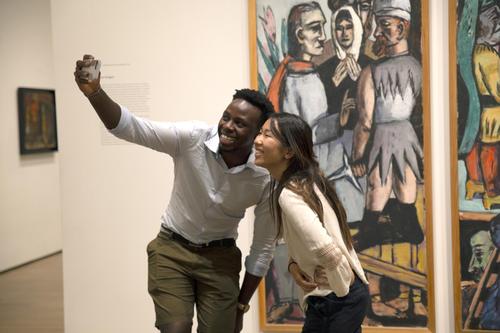 Visitors pose for a selfie in front of Max Beckmann’s Actors.