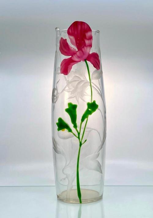 Moser 16 ½ inch tall bulbous vase in clear glass, engraved with a floral design and marquetry inset with a marquetry carved flower on a slender stem (est.  $1,000-$2,000).  