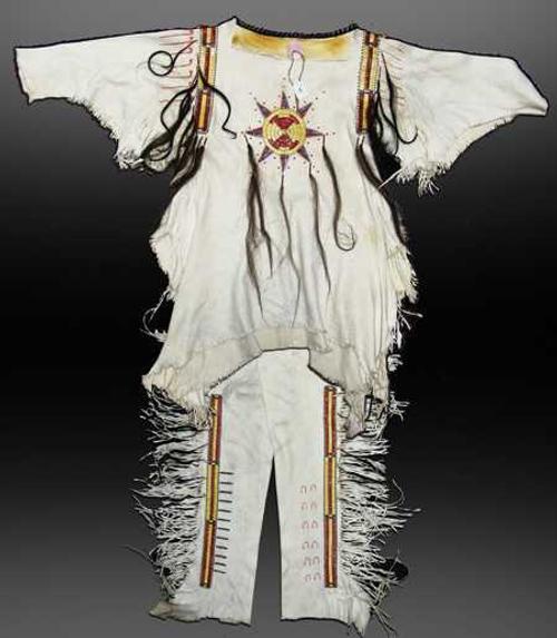 This early 1900s hand-crafted white buckskin Mandan war shirt with matching leggings should realize $4,000-$8,000.