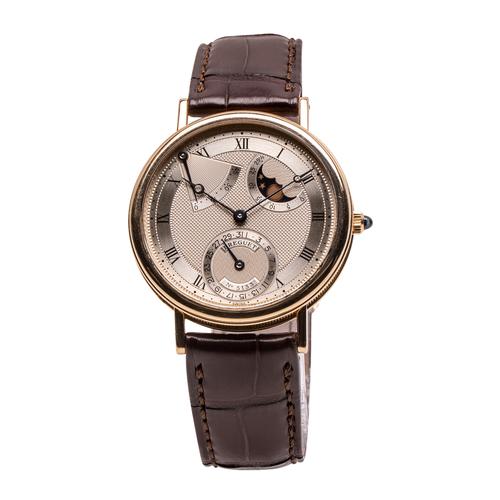 Circa 1996 Breguet Classique Swiss watch with an elegant 19kt yellow gold case and a dial featuring a power-reserve indicator and phases and age of the moon (est.  CA$30,000-$40,000).