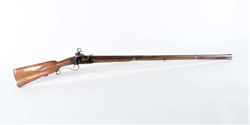 Spanish circa 1760 Miquelet musket fusil with a .69 bore at the flared muzzle, 51 inches long (the barrel 35 ½ inches), with an ornately carved walnut stock (est.  $2,000-$3,000).