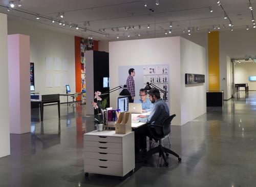 Installation view of "Graphic Design: Now in Production," on view March 28–August 3, 2014.  RISD Museum, Providence, RI.  Shown: RISD Museum graphic designers Derek Schusterbauer and Brendan Campbell in the exhibition's "Office of Now."